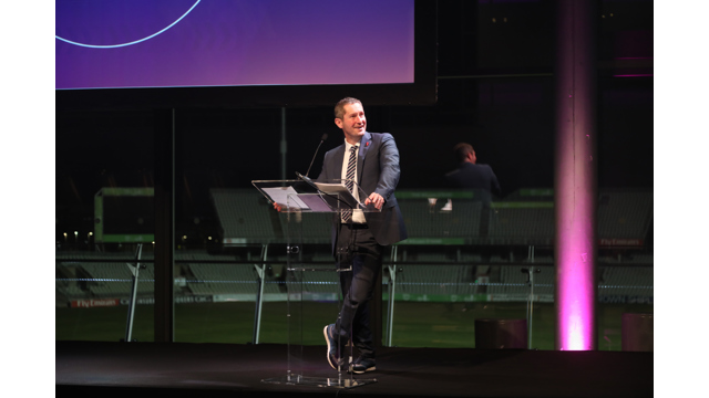 Mike Perls speaking behind lectern at the GM Sports Awards